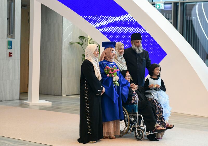 Family and friends take photos with the graduates at the Mohamed bin Zayed University of Artificial Intelligence commencement of class 2023 ceremony.
