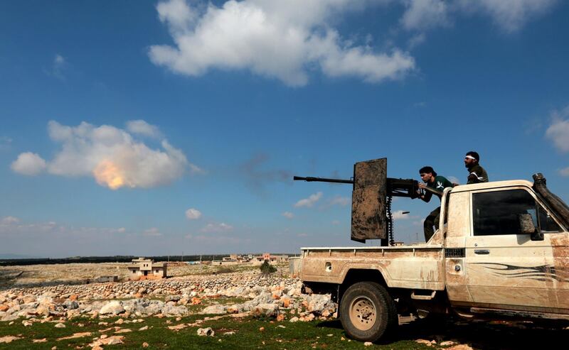 epa06600956 Turkey-backed Free Syrian Army soldiers shoot with heavy machine gun during an offensive, at Der Mismis Village, southeast of Afrin, Syria, 13 March 2018. According to media reports, the Turkish army and its allied Syrian militias on 10 March continued to encircle the city of Afrin in the Kurdish-held enclave of the same name in northwest Syrian, taking control of nine towns. The Turkish army on 20 January launched 'Operation Olive Branch' in Syria's northern regions against the Kurdish Popular Protection Units (YPG) forces and the Syrian Democratic Forces (SDF) which control the city of Afrin. Turkey classifies the YPG as a terrorist organization. The Turkish-backed Free Syrian Army is an armed rebel military group that operates in northern Syria and is supported by the Turkish army.  EPA/STR