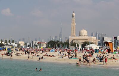 People enjoying the Sunday holiday with their family members at the Kite beach in Dubai. Pawan Singh / The National