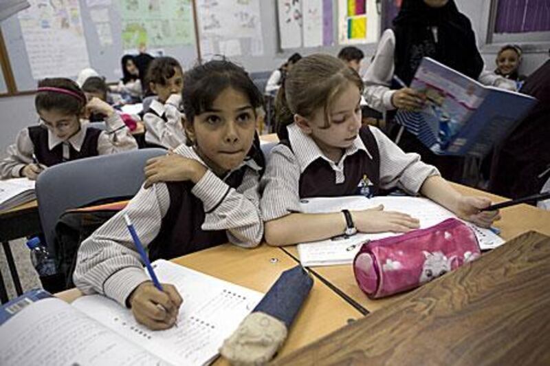 Basma Yaslam, 10, from Yemen , left, and Noor Gawdat, 9, from Palestine, attend night classes at the National Charity School in Dubai.