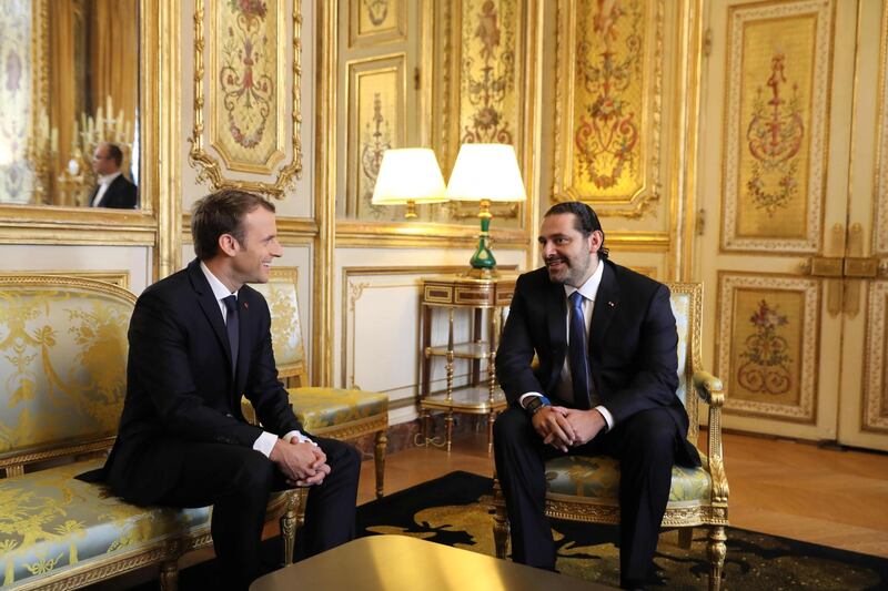 French president Emmanuel Macron, left, and Saad Hariri chat at the Elysee Palace on November 18, 2017. Mr Hariri was also scheduled to have lunch with Mr Macron. AFP