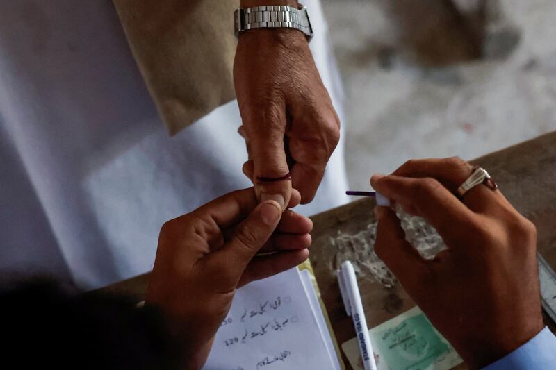 A voter in Karachi gets an ink mark on his thumb after casting his vote during the general election. Reuters