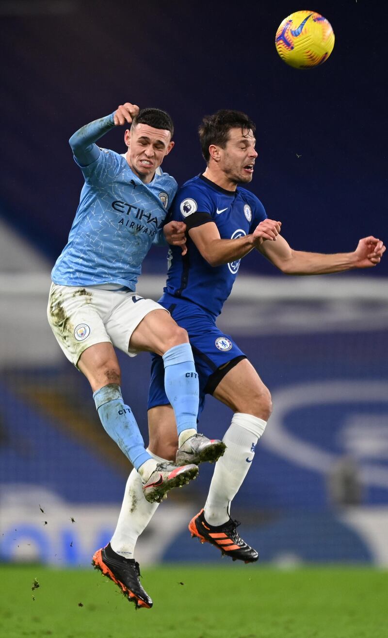 Chelsea's Cesar Azpilicueta and Phil Foden of City challenge for a header. EPA
