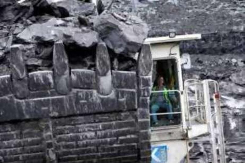 Coal is moved by heavy machinery at the Lodge House surface coal mine operated by U.K. Coal Plc., in Ilkeston, U.K., on Wednesday, Aug 4, 2010. U.K. Coal Plc., is the country's biggest producer of the fuel.  Photographer: Chris Ratcliffe/Bloomberg *** Local Caption ***  712601.jpg