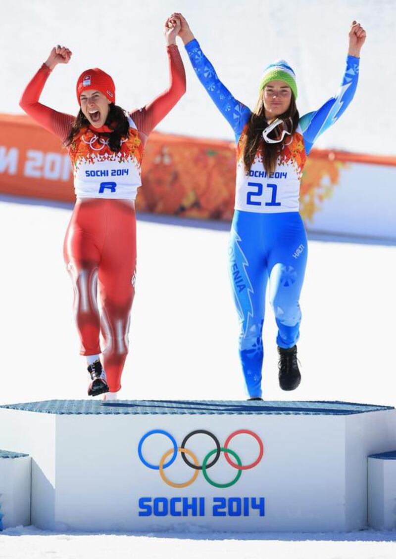 Dominique Gisin of Switzerland, left, and Tina Maze of Slovenia step up to the top of the podium to accept their gold medals after tying in the Alpine Skiing Women's Downhill. Richard Heathcote / Getty Images