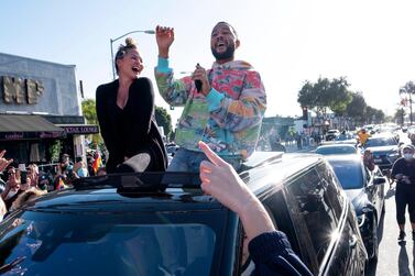 John Legend and Chrissy Teigen celebrate President-elect Joe Biden's win with a drive-by parade on November 7 in Hollywood. Getty Images