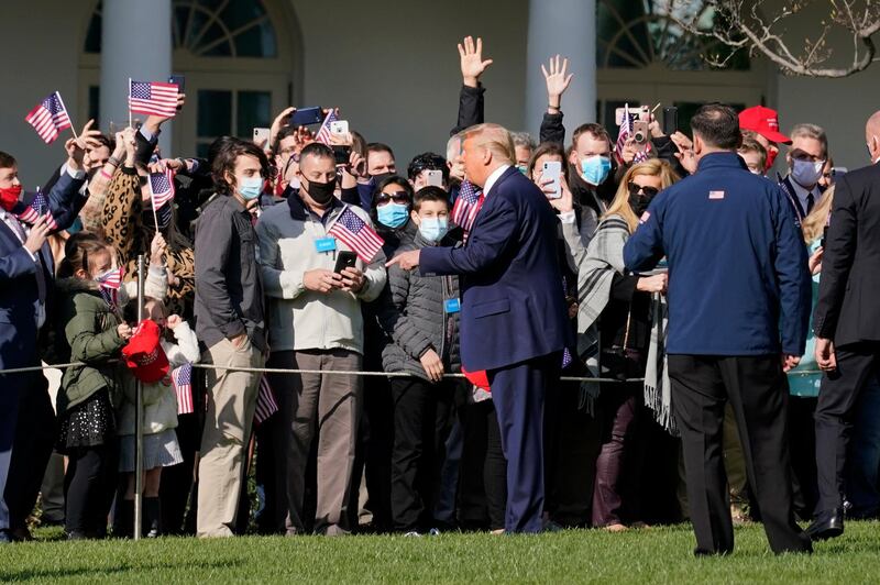 President Donald Trump speaks to supporters as he departs the South Lawn of the White House.  AP