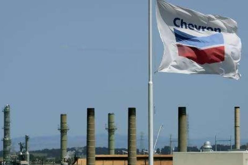 A Chevron flag flies over the Chevron refinery Monday, April 21, 2008, in Richmond, Calif. Rising gasoline prices tightened the squeeze on drivers Monday, jumping to an average $3.50 a gallon at filling stations across the country. (AP Photo/Ben Margot)