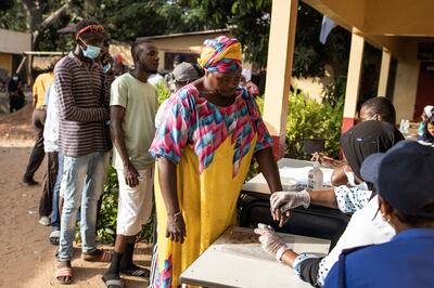 A woman gets her finger marked with ink before casting her vote in the Gambian presidential election. AFP