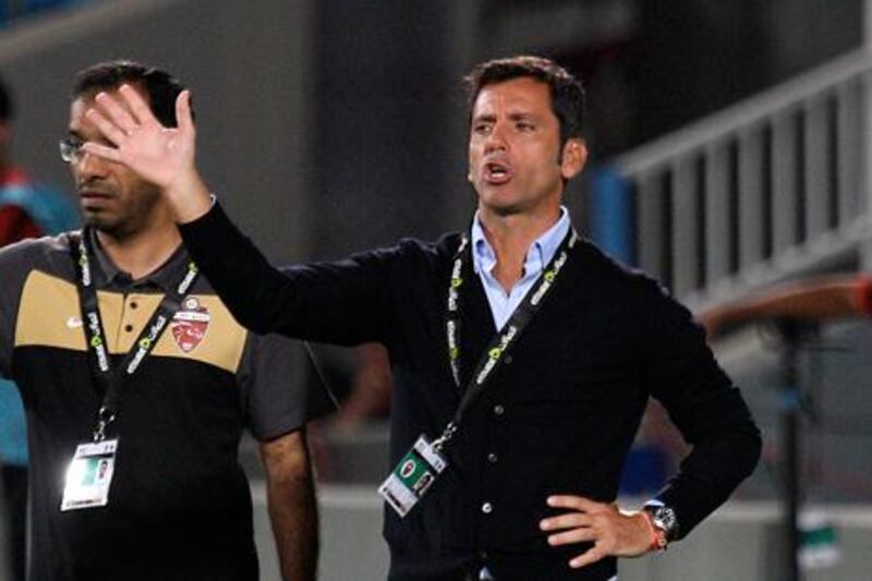 Al Ahli coach Quique Sanchez Florez oversees his side's defeat of Baniyas.