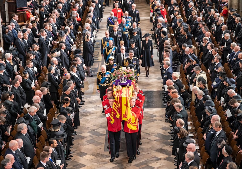King Charles III follows the coffin of Queen Elizabeth as it leaves Westminster Abbey after her state funeral in September 2022