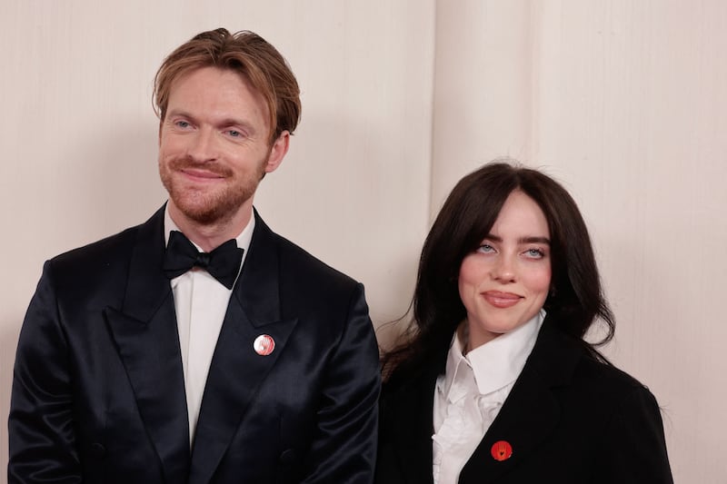 (From L) Finneas O'Connell and US singer-songwriter Billie Eilish wear an "Artists4Ceasefire" pin, calling for de-escalation and ceasefire in Gaza and Israel as they attend the 96th Annual Academy Awards at the Dolby Theatre in Hollywood, California on March 10, 2024.  (Photo by DAVID SWANSON  /  AFP)