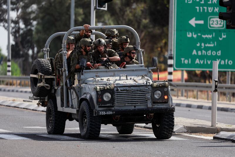 Israeli military drive on a road in southern Israel, as rockets are launched from the Gaza Strip, outside Sderot. Reuters