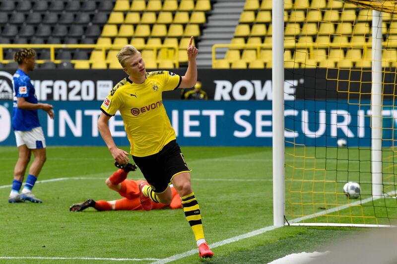 PA via Reuters
Dortmund's Erling Haaland celebrates after scoring the opening goal during the German Bundesliga soccer match between Borussia Dortmund and Schalke 04 in Dortmund, Germany.