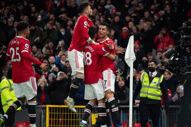 Manchester United's Cristiano Ronaldo celebrates with teammates after scoring the 2-1 during the English Premier League soccer match between Manchester United and Arsenal FC in Manchester, Britain, 02 December 2021.   EPA/PETER POWELL EDITORIAL USE ONLY.  No use with unauthorized audio, video, data, fixture lists, club/league logos or 'live' services.  Online in-match use limited to 120 images, no video emulation.  No use in betting, games or single club / league / player publications