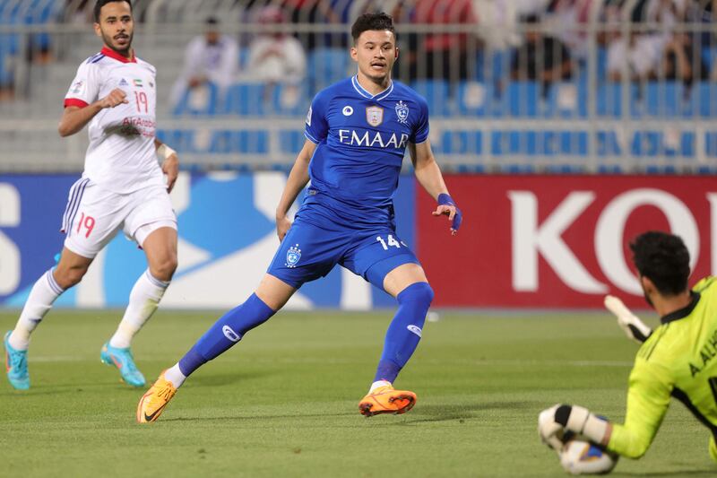 Hilal forward Abdullah al-Hamdan has his shot saved by Sharjah goalkeeper Adel al-Hosani.