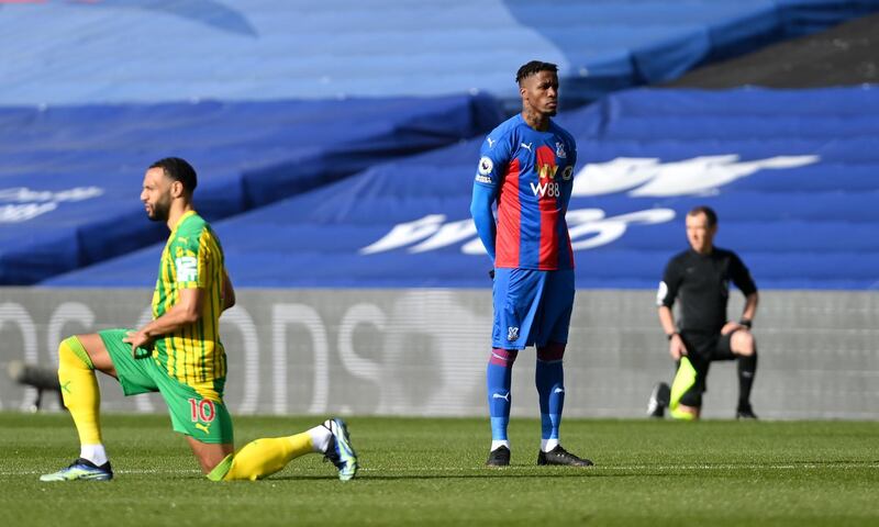 Crystal Palace's Wilfried Zaha stands while players take a knee prior to the Premier League match against West Brom at Selhurst Park on Saturday, March 13, 2021. PA