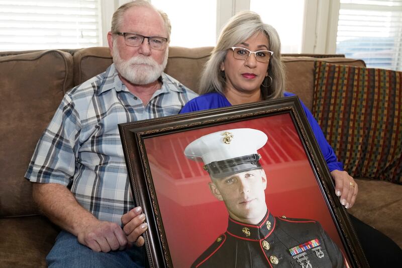 Joey and Paula Reed hold a portrait of their son Trevor at their home in Fort Worth, Texas. AP Photo