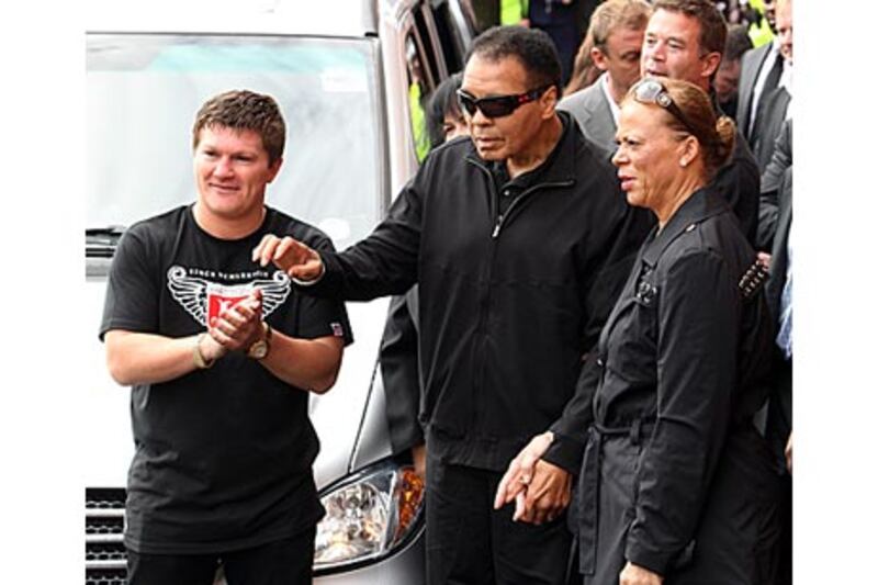 Ali's big entourage, along with his wife Lonnie, do little to add to the atmosphere during his public appearances like this one with Ricky Hatton, left, as part of his UK charity tour in Manchester.