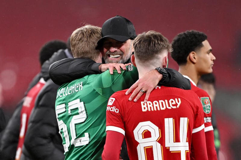 Liverpool manager Jurgen Klopp, centre, hugs goalkeeper Caoimhin Kelleher and defender Conor Bradley after the 1-0 victory over Chelsea in the League Cup final. Getty