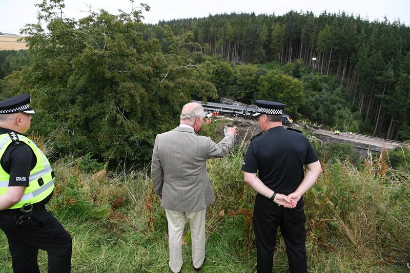 STONEHAVEN, SCOTLAND - AUGUST 14:  Prince Charles, Prince of Wales looks over at the scene of the ScotRail train derailment near Stonehaven, Aberdeenshire, which cost the lives of three people people on August 14, 2020 in Stonehaven, Scotland. Prince Charles, known as the Duke of Rothesay while in Scotland, visited the site to thank those who were among the first on the scene. (Photo by Ben Birchall - WPA Pool/Getty Images)