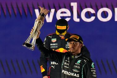 Mercedes driver Lewis Hamilton of Britain celebrates winning the Formula One Saudi Arabian Grand Prix in front of the second placed Red Bull driver Max Verstappen of the Netherlands, in Jiddah, Sunday, Dec.  5, 2021.  (AP Photo / Hassan Ammar)