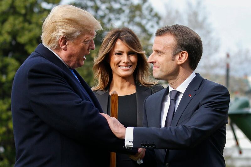 US President Donald Trump (L), with First Lady Melania Trump (C) shakes hands with French President Emmanuel Macron (R) during a tree planting ceremony on the South Lawn of the White House in Washington, DC, USA, on April 23, 2018. Shawn Thew / EPA