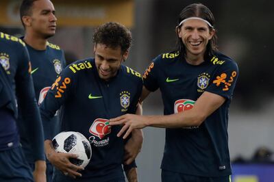 Brazil's Filipe Luis, right, embraces Neymar during a practice session of the Brazilian national soccer team ahead the World Cup in Russia, at the Granja Comary training center In Teresopolis, Brazil, Friday, May 25, 2018. (AP Photo/Leo Correa)