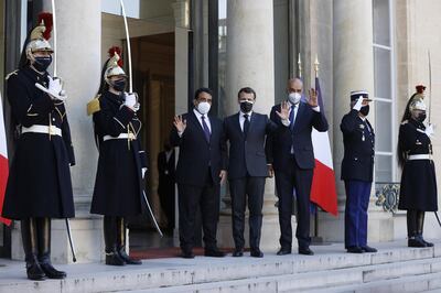 epa09092148 French President Emmanuel Macron (C) welcomes Head of Libya's Presidential Council, Mohamed al-Menfi (L) and Vice President of Libya's Presidential Council, Musa Al-Koni (R) for a meeting at Elysee Palace in Paris, France, 23 March 2021.  EPA/IAN LANGSDON