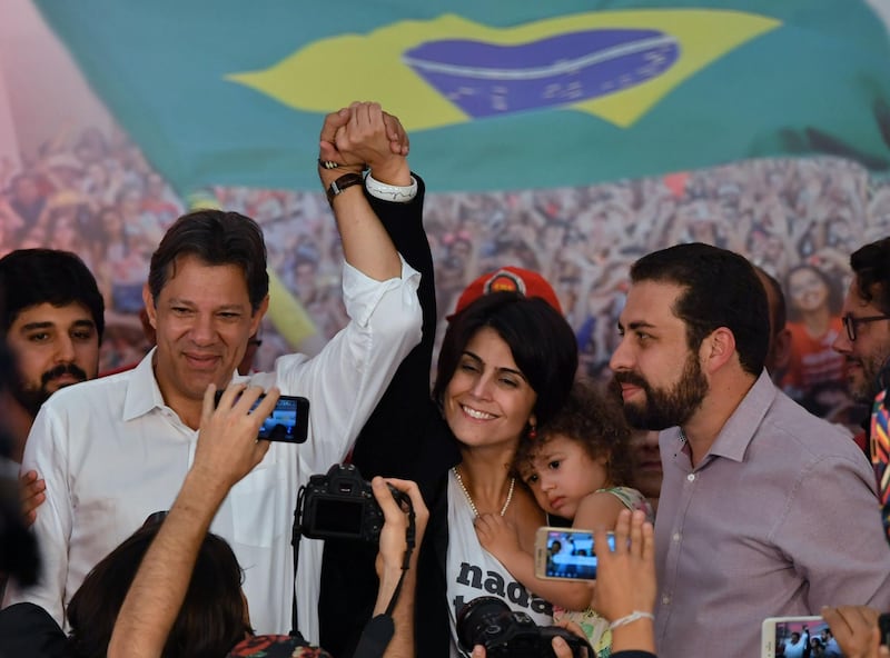 The presidential candidate for the Workers' Party, Fernando Haddad (left) and his running mate Manuela d'Avila (centre), addresses supporters in Sao Paolo. AFP