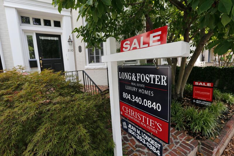 FILE - In this Aug. 16, 2019, file photo a for sale signs beckon buyers to homes along Park Avenue in Richmond, Va. On Thursday, Dec. 26, Freddie Mac reports on this weekâ€™s average U.S. mortgage rates. (AP Photo/Steve Helber, File)