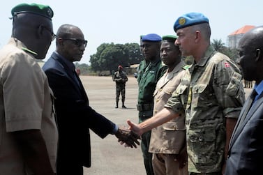 Guinea's President Alpha Conde shakes hand with general Michael Lollesgaard in 2016. AFP