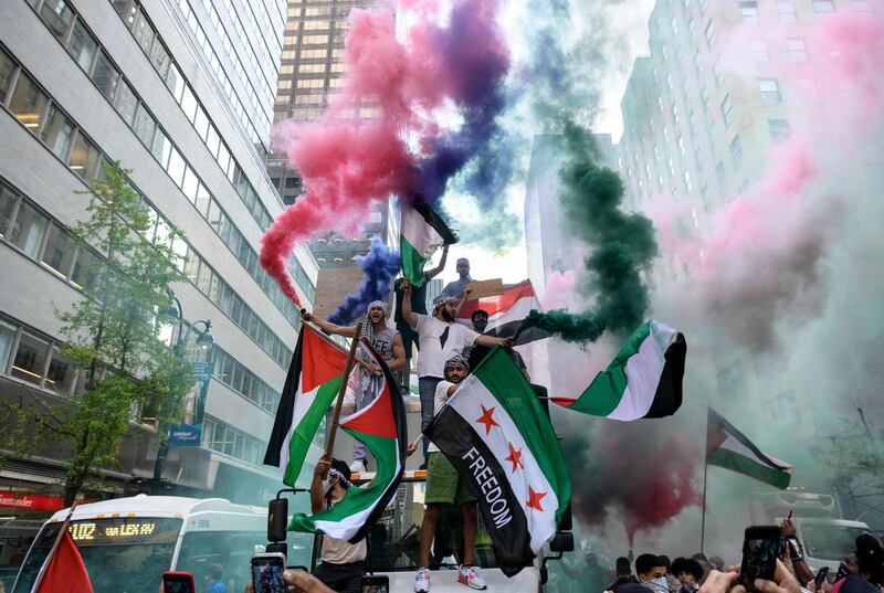 Demonstrators in midtown Manhattan, New York City, hold Palestine and Syrian flags in support of Palestinians in the Gaza Strip. AFP