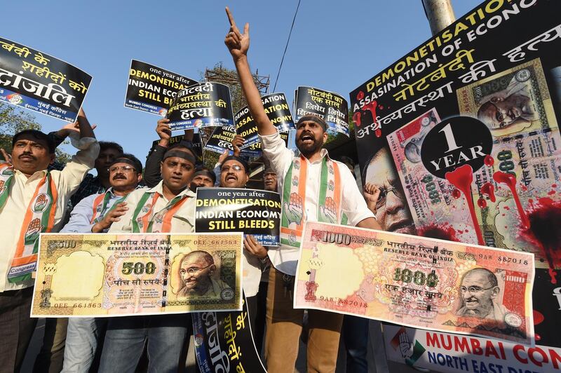 Indian Congress party supporters shout slogans and hold placards during a protest on the eve of the first anniversary of India's demonetisation scheme in Mumbai on November 7, 2017. 
Prime Minister Narendra Modi's shock decision November 8, 2016 to devalue India's high-value rupee bills was intended to root out tax evasion. But the move wrought havoc on businesses in Asia's third-largest economy, causing growth to slump to levels not seen since Modi was elected in 2014.  / AFP PHOTO / INDRANIL MUKHERJEE