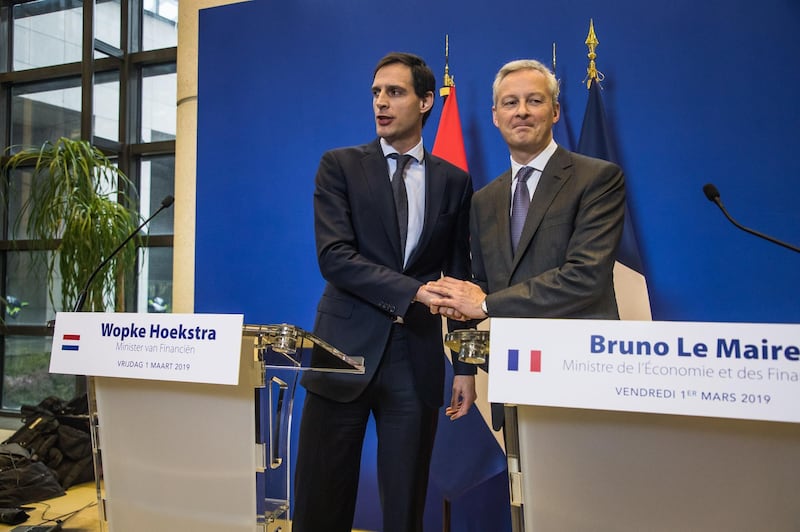 epa07405838 French Finance Minister Bruno Le Maire (R) and and his Dutch counterpart Wopke Hoekstra (L) shake hands at the press conference following their meeting at the French Finance ministry in Paris, France, 01 March 2019. The Dutch State has acquired an interest in the Air France-KLM holding company.  EPA/CHRISTOPHE PETIT TESSON