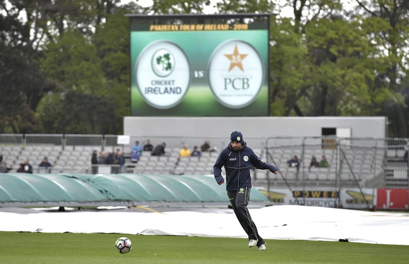 Ireland fast bowler Stuart Thompson plays football on a rain-sodden pitch as Ireland prepare to play their first ever cricket Test against Pakistan on Friday in Malahide, Ireland. Charles McQuillan / Getty Images