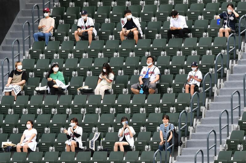 Baseball fans sit in the stands as they observe social distancing at Jamsil stadium in Seoul. AFP