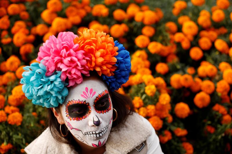 A woman dressed up as 'Catrina', a Mexican character also known as 'The Elegant Death', takes part in a Catrinas parade in Mexico City. Carlos Jasso / Reuters