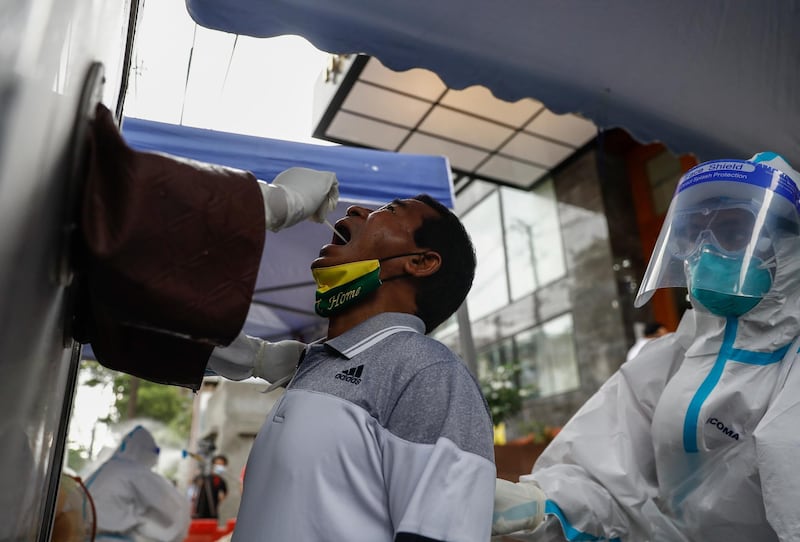 A member of parliament undergoes a swab test for coronavirus ahead of parliament session in Yangon, Myanmar. EPA