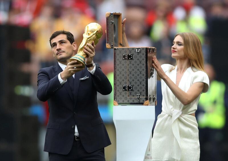 Iker Casillas and model Natalia Vodianova present the World Cup trophy before the ceremony. Carl Recine / Reuters