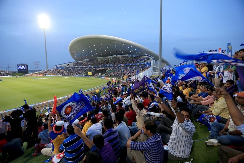Mumbai Indians fans cheer they team on the opening match between Mumbai Indians and Kolkata Knight Riders in IPL 2014 at Zayed Cricket Stadium in Abu Dhabi. Ravindranath K / The National