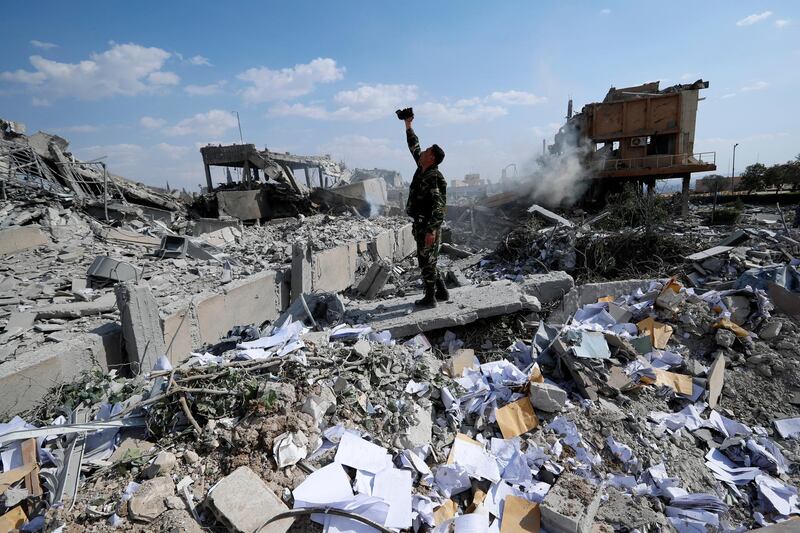 A Syrian soldier films the damage of the Syrian Scientific Research Center which was attacked by U.S., British and French military strikes to punish President Bashar Assad for suspected chemical attack against civilians, in Barzeh, near Damascus, Syria, Saturday, April 14, 2018. The Pentagon says none of the missiles filed by the U.S. and its allies was deflected by Syrian air defenses, rebutting claims by the Russian and Syrian governments. Lt. Gen. Kenneth McKenzie, the director of the Joint Staff at the Pentagon, also says there also is no indication that Russian air defense systems were employed early Saturday in Syria. AP Photo / Hassan Ammar