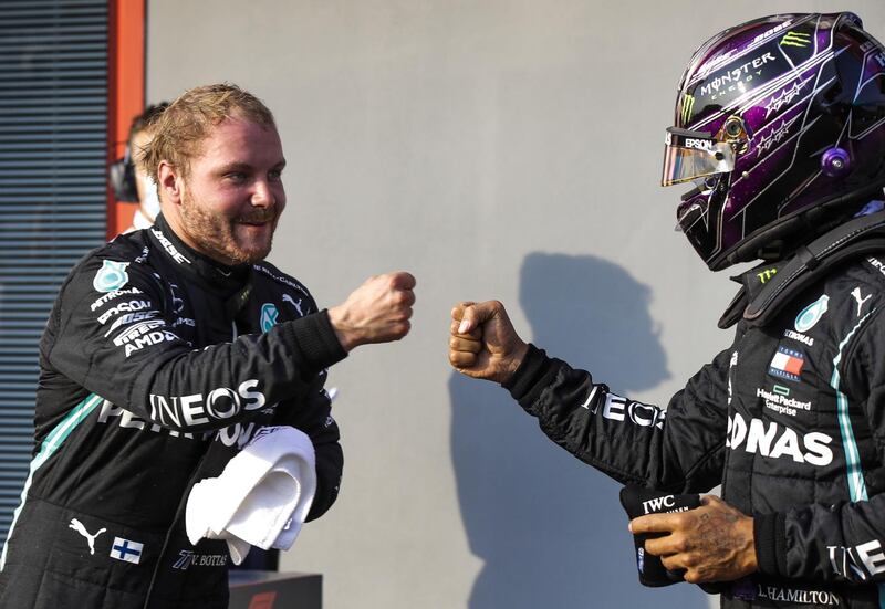 epa08788531 Finnish Formula One driver Valtteri Bottas (L) of Mercedes-AMG Petronas celebrates with British Formula One driver Lewis Hamilton (R) of Mercedes-AMG Petronas taking the pole position after the qualifying session of the Formula One Emilia Romagna Grand Prix  at the race track in Imola, Italy,on 31 October 2020.The Formula One Emilia Romagna Grand Prix will take a place on 01 November 2020.  EPA/Luca Bruno / Pool