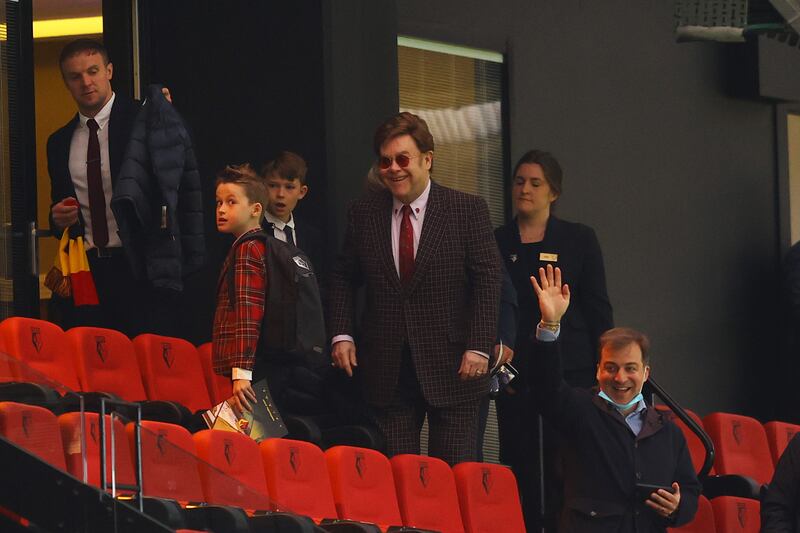 Elton John, in a checked shirt, watches a football match between Watford and Swansea City in Watford on May 8, 2021. Getty Images