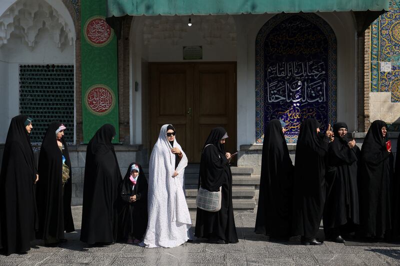 Iranians wait in line to vote at a polling station during parliamentary elections in Tehran, Iran. Reuters