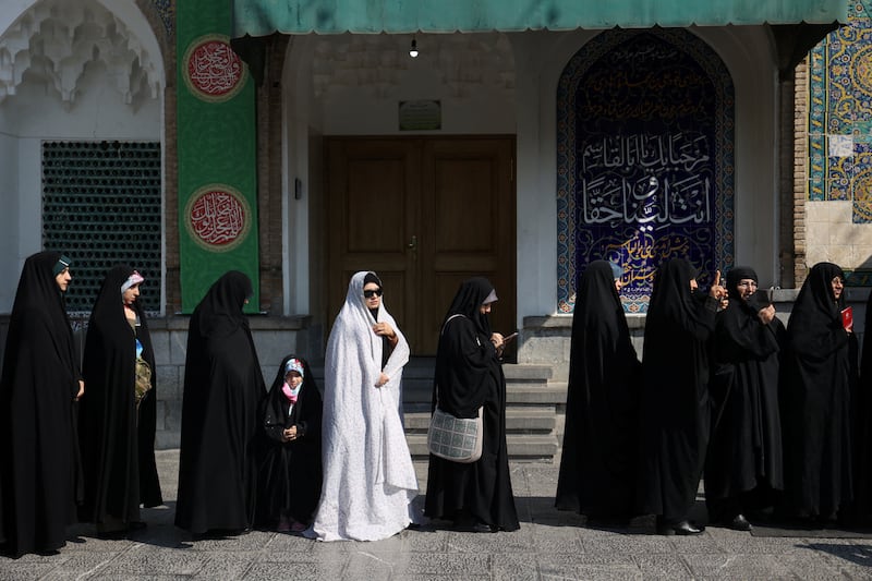 Iranians wait in line to vote at a polling station during parliamentary elections in Tehran, Iran. Reuters