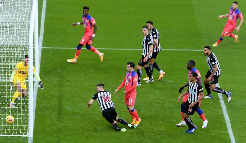 Federico Fernandez, centre left, of Newcastle scores an own goal against Chelsea on Saturday. EPA