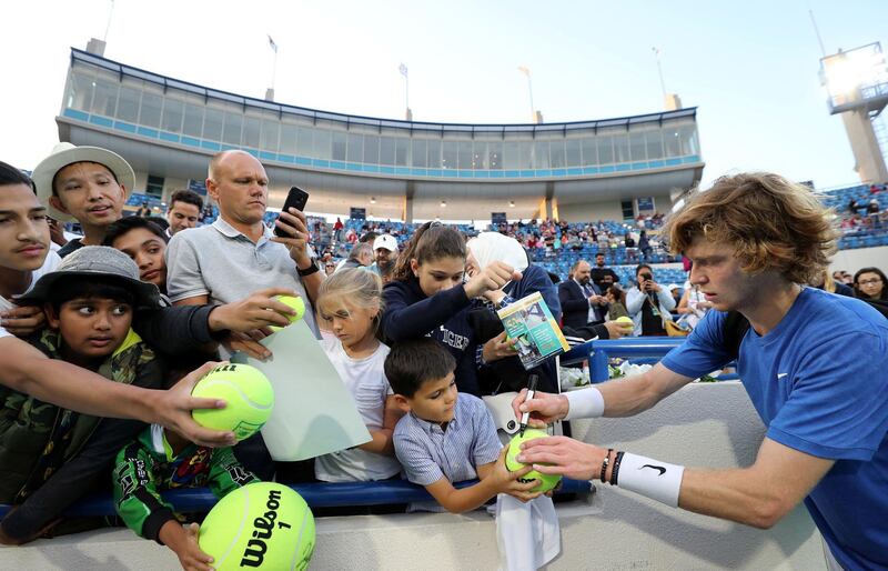 Abu Dhabi, United Arab Emirates - Reporter: Jon Turner: Fans get autographs from Andrey Rublev after the match between Stefanos Tsitsipas v Andrey Rublev at the Mubadala World Tennis Championship. Thursday, December 19th, 2019. Zayed Sports City, Abu Dhabi. Chris Whiteoak / The National