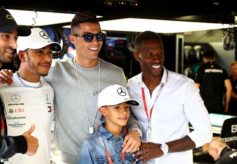 Cristiano Ronaldo, second left, poses with  Lewis Hamilton, left, during his visit to the Monaco Grand Prix. Getty