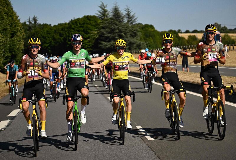 Left to right: Jumbo-Visma's Tiesj Benoot holding the bib number of absent teammate Nathan Van Hooydonck, Wout Van Aert, Jonas Vingegaard, Sepp Kuss holding the number of Primoz Roglic, and Christophe Laporte holding the number of Steven Kruijswijk. AFP